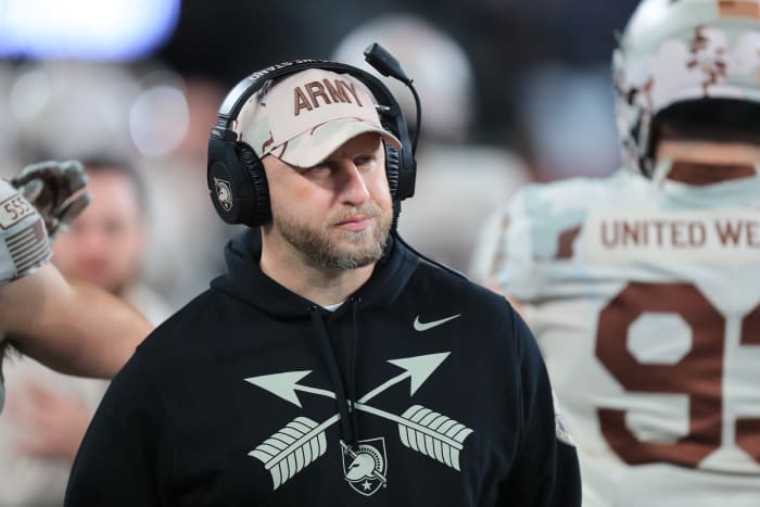Matt Drinkall walks along the Army sidelines during a timeout.